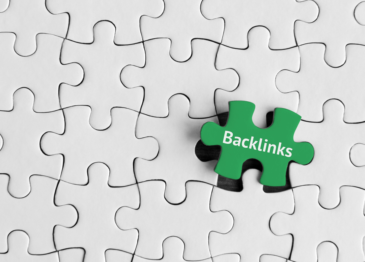 A concept of SEO link building - a puzzle piece containing the word backlinks.